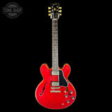 Red electric guitar on a black background with 'Tone Shop' logo.