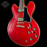 Red electric guitar with a black background