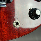 Close-up of a guitar's control knob and wood grain