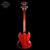Red electric guitar on a black background with 'Tone Shop' logo.