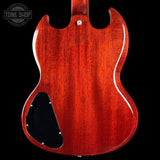 Back view of a red electric guitar with a visible brand logo in the corner.