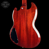 Red electric guitar body with a visible brand logo in the corner.