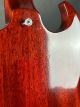 Close-up of a guitar's wooden neck with a metal screw.