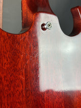 Close-up of a wooden object with a metal screw, possibly a guitar or a similar instrument.