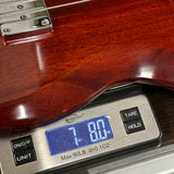 Digital scale displaying weight of a wooden object