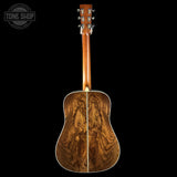 Wooden acoustic guitar on a black background with 'Tone Shop' logo.