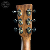Close-up of a guitar headstock with six tuning pegs and decorative metal tuners on a dark background. A Tone Shop watermark is visible in the top left corner.