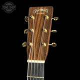 Close-up of a guitar headstock with 'Martin' logo on a black background