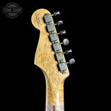 Guitar headstock with tuning pegs on a black background, featuring the Tone Shop logo.