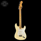 White electric guitar with a visible brand logo on a black background