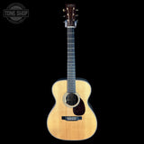Acoustic guitar on a black background with 'Tone Shop' logo.
