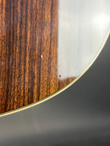 Close-up of a wooden surface with a metallic rim on a gray background