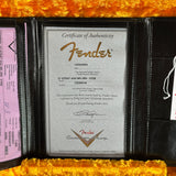 Fender certificate of authenticity with a guitar on a yellow textured background