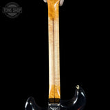 Guitar neck with a black background and 'Tone Shop' logo.