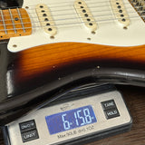 Guitar on a digital scale displaying weight