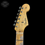 Close-up of a Fender guitar headstock on a black background with 'Tone Shop' logo.