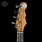 Close-up of a guitar headstock with 'Reverend' branding on a black background.