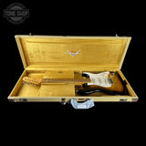 Fender electric guitar in a gold case with Fender logo, Tone Shop branding.