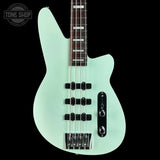 Light blue bass guitar on a black background with 'Tone Shop' logo.