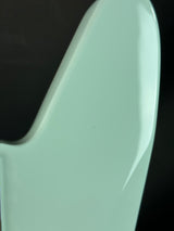 Close-up of a light green plastic object on a black background