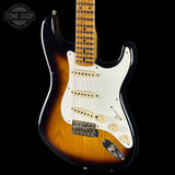 Fender Stratocaster guitar with a sunburst finish on a black background, featuring the Tone Shop logo.