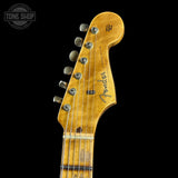 Close-up of a Fender guitar headstock on a black background