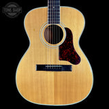 Acoustic guitar with a visible brand logo in the corner