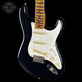 Black electric guitar with white pickguard on a black background, featuring 'Tone Shop' logo.