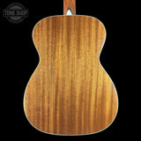 Back view of a wooden acoustic guitar with 'Tone Shop' logo.