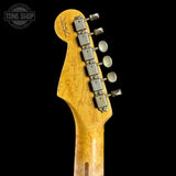 Guitar headstock with tuning pegs on a black background, featuring the Tone Shop logo.