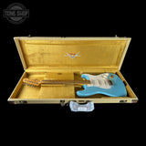 Blue electric guitar in a gold case with Fender logo, Tone Shop branding.
