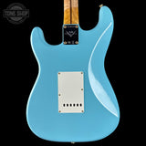 Blue electric guitar with a visible brand logo on a black background