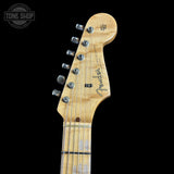 Close-up of a Fender electric guitar headstock on a black background