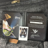 Gibson Memphis certificate of authenticity for a guitar, with a photo of a person playing guitar and a guitar image.