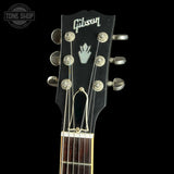 Gibson guitar headstock with brand logo on a black background