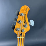 Close-up of a guitar headstock with brand name on a dark background