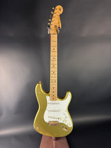 Gold electric guitar on a dark background