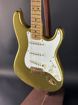 Gold electric guitar on a dark gray background