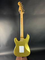 Gold electric guitar on a dark background