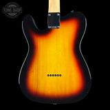 Close-up of the back of a classic electric guitar with a sunburst finish, showing the black outer edge fading to a bright amber-orange center, set against a solid black background.