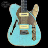 Vintage-style electric guitar with a distressed turquoise finish on a black background.