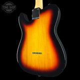 The back of a classic electric guitar with a sunburst finish, showing a bright orange center fading to black around the edges, photographed against a solid black background.