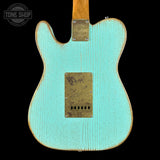 Back of a turquoise electric guitar with a visible brand logo on a black background