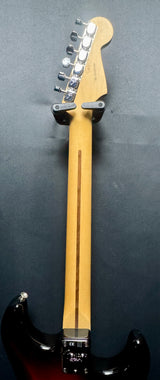 Guitar neck with headstock on a dark background