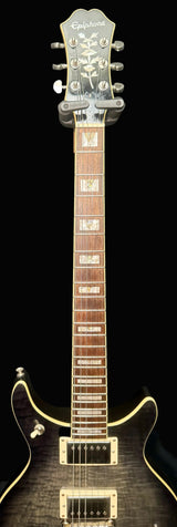 Electric guitar with a dark finish on a gray background