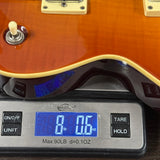 Used ESP LTD EC-400VF Sunburst on scale displaying weight.