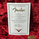 Fender Certificate of Authenticity on a red textured surface