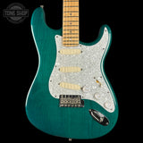 Teal electric guitar with a pearlized pickguard on a black background, featuring 'Tone Shop' branding.