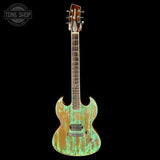 Distressed green electric guitar on a black background with 'Tone Shop' logo.