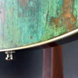 Close-up of a textured green surface with a metallic edge on a dark background